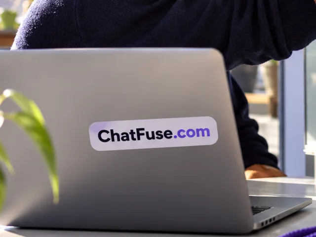 A man sketching a workflow on glass beside a laptop labeled ChatFuse.com